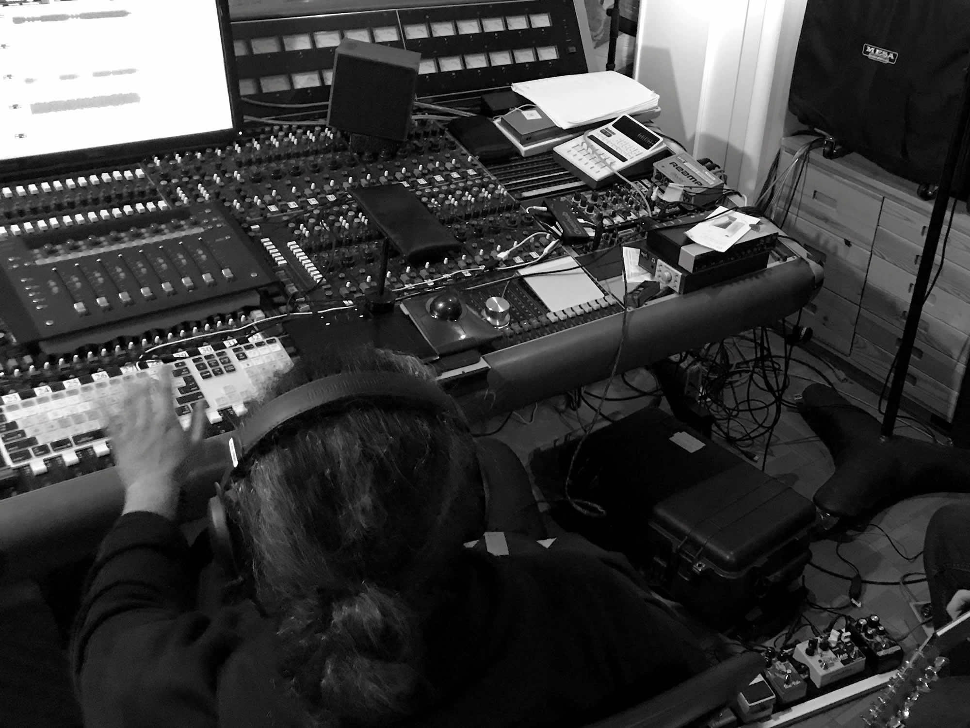 Music producer Vladi Vargas working on Jim Castro song in front of mixing console